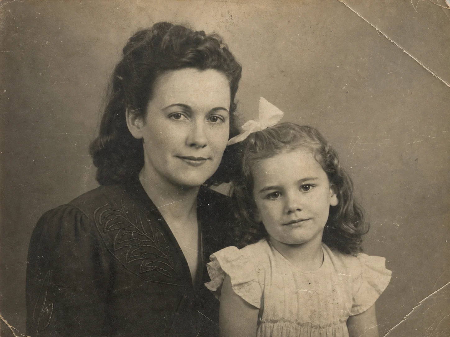 Damaged black-and-white family portrait before AI restoration